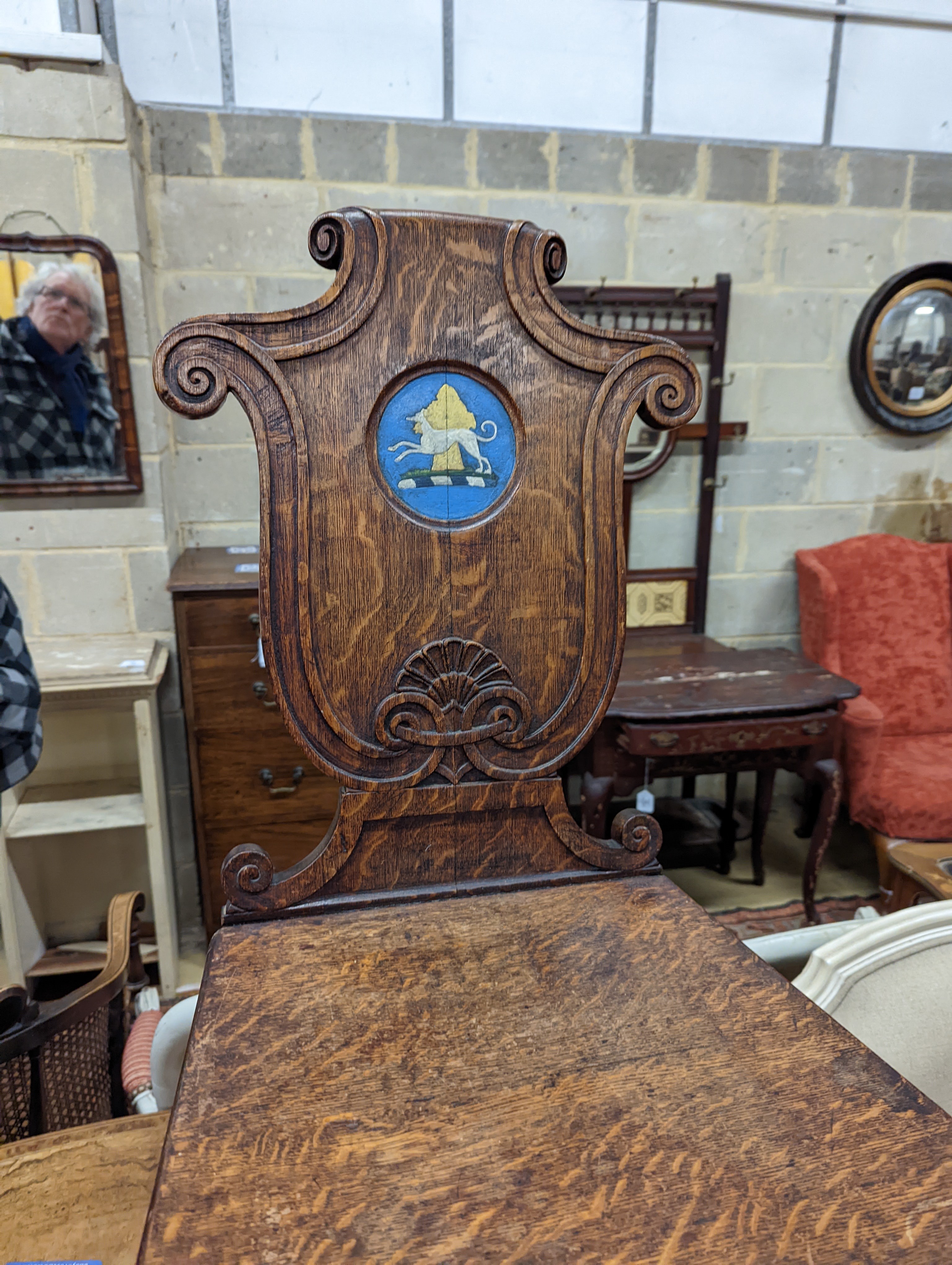 A pair of Victorian oak hall chairs with painted armorials, width 43cm, depth 39cm, height 94cm